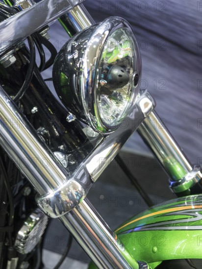 Motorbike headlight with green details and shiny chrome, dortmund, germany