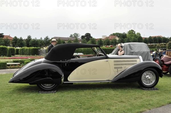 Retro Classics meets Baroque, Ludwigsburg, Baden-Württemberg, Germany, Europe Black and beige convertible on a green lawn, elegant and stylish, Europe
