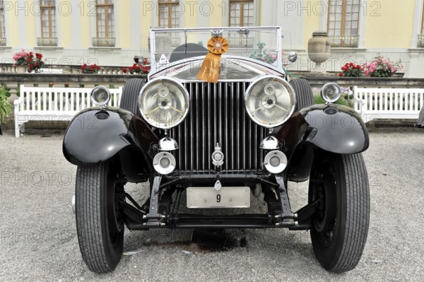 Black classic vintage car with red ribbon, elegant in front of flower bed, Retro Classics meets Baroque, Ludwigsburg, Baden-Württemberg, Germany