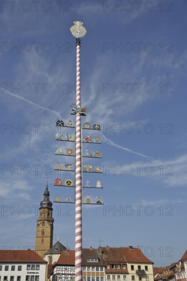 Guild pole with symbols for historical professions, pole with guild sign, craftsmen, maypole, church tower, Assumption of the Virgin Mary, market square, Bad Königshofen, Rhön, Lower Franconia, Franconia, Bavaria, Germany