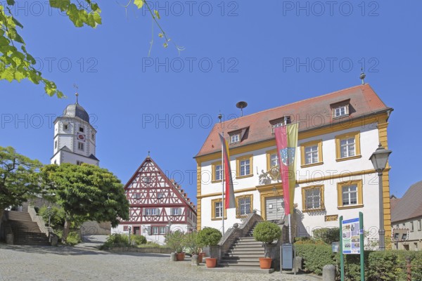 St. Nicholas Church built in 1510, cantor's house built in 1510 and baroque town hall built in 1739 with German national flag and town flag, half-timbered house, town hall square, Winterhausen, Eibelstadt, Lower Franconia, Franconia, Bavaria, Germany
