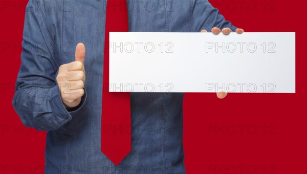 Male person holding a white blank sign in red back