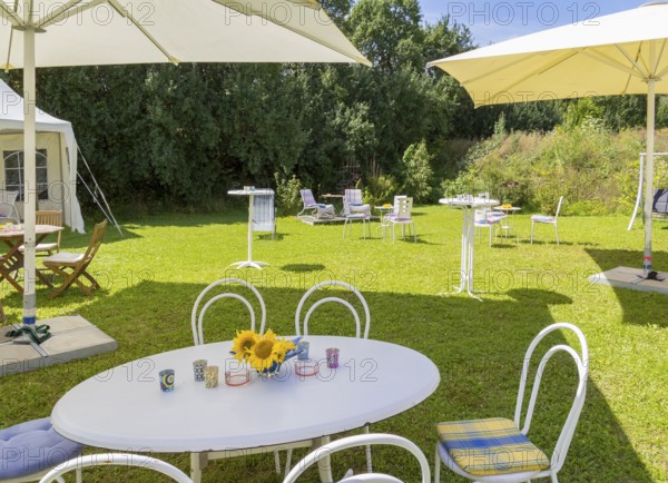 Sunny illuminated idyllic scenery showing a garden prepared for party