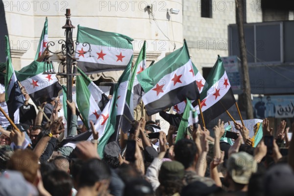 Thousands of Syrians march in Idlib carrying the Syrian revolutionary flag during a protest against international calls to normalize relations with Bashar al-Assad's regime. Aleppo, Syria. July 2, 2024, Aleppo, Aleppo, Syria