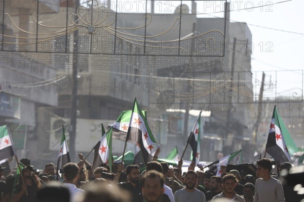 Thousands of Syrians march in Idlib carrying the Syrian revolutionary flag during a protest against international calls to normalize relations with Bashar al-Assad's regime. Aleppo, Syria. July 2, 2024, Aleppo, Aleppo, Syria