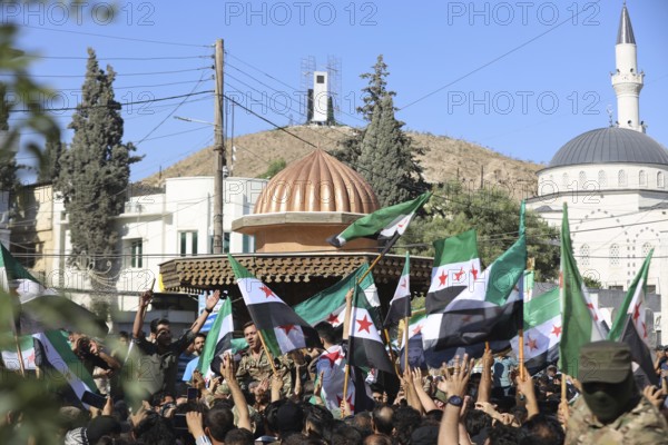 Thousands of Syrians march in Idlib carrying the Syrian revolutionary flag during a protest against international calls to normalize relations with Bashar al-Assad's regime. Aleppo, Syria. July 2, 2024, Aleppo, Aleppo, Syria