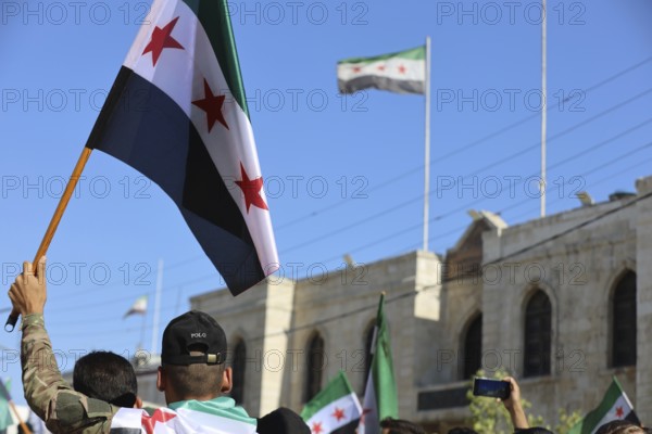 Thousands of Syrians march in Idlib carrying the Syrian revolutionary flag during a protest against international calls to normalize relations with Bashar al-Assad's regime. Aleppo, Syria. July 2, 2024, Aleppo, Aleppo, Syria