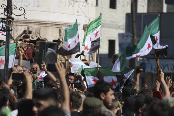 Thousands of Syrians march in Idlib carrying the Syrian revolutionary flag during a protest against international calls to normalize relations with Bashar al-Assad's regime. Aleppo, Syria. July 2, 2024, Aleppo, Aleppo, Syria