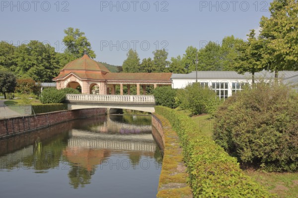 Wernarz spring temple built in 1911 and bridge over the river Sinn, temple, art nouveau, reflection, foyer, spa gardens, state bath, Bad Brückenau, Rhön, Bavaria, Germany