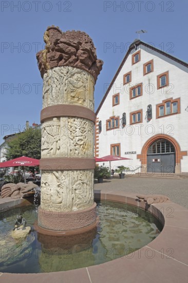 Fairytale fountain with reliefs of fairytale figures and town hall, market square, Steinau an der Straße, Spessart, Hesse, Germany