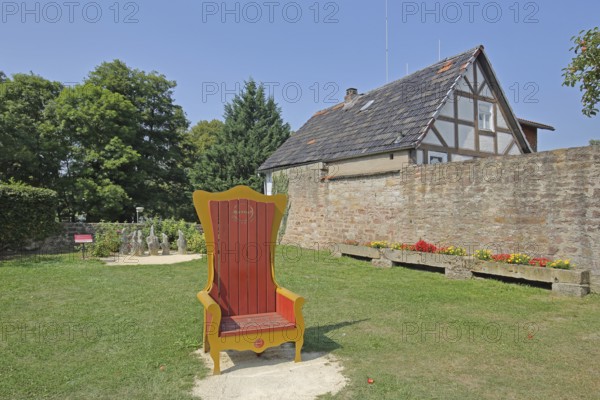 Red golden throne in the inner courtyard, garden, museum, Brothers Grimm House, Steinau an der Straße, Spessart, Hesse, Germany