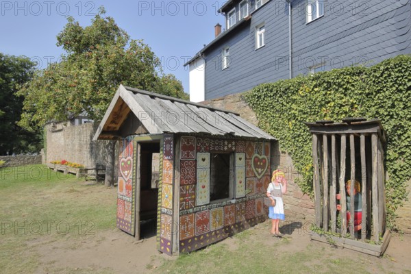 Gingerbread house for the fairy tale Hansel and Gretel, fairy tale figures, hut, wooden posts, locked up, trapped, bars, wooden fence, Brothers Grimm House, Steinau an der Straße, Spessart, Hesse, Germany