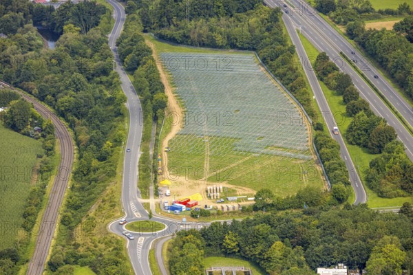 Aerial view, field with construction site for ground-mounted photovoltaic plant solar park at the motorway A46, roundabout Casparistraße, Uentrop, Arnsberg, Ruhr area, North Rhine-Westphalia, Germany, construction work, construction area, building site, building plots, construction project, construction site, DE, Europe, photovoltaic, aerial view, aerial photography, aerial photography, new construction, photovoltaic plant, solar, solar plant, solar energy, solar power plant, overview, bird's eye view, bird's eye view, overview