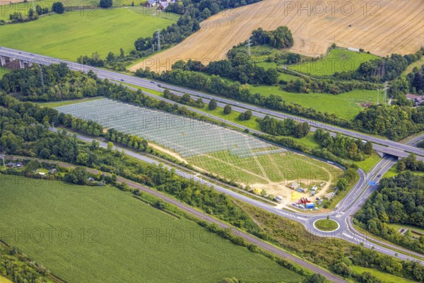 Aerial view, field with construction site for ground-mounted photovoltaic plant solar park at the motorway A46, roundabout Casparistraße, Uentrop, Arnsberg, Ruhr area, North Rhine-Westphalia, Germany, construction work, construction area, building site, building plots, construction project, construction site, DE, Europe, photovoltaic, aerial view, aerial photography, aerial photography, new construction, photovoltaic plant, solar, solar plant, solar energy, solar power plant, overview, bird's eye view, bird's eye view, overview