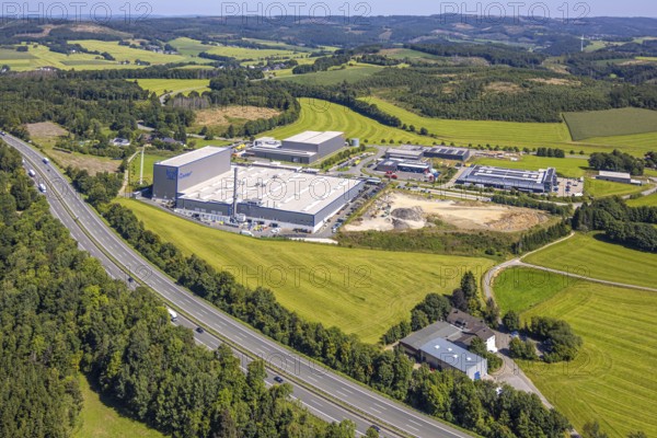 Aerial view, industrial area, industrial park Grünewald with construction site, motorway A45, hilly landscape with forest area, Drolshagen, Sauerland, North Rhine-Westphalia, Germany, motorway, DE, Europe, commercial enterprises, commercial area, commercial area, commercial property, commercial park, commercial location, commercial use, industrial area, industrial location, aerial view, aerial photography, aerial photography, Ruhr area, road traffic, overview, bird's eye view, birds-eyes view, overview