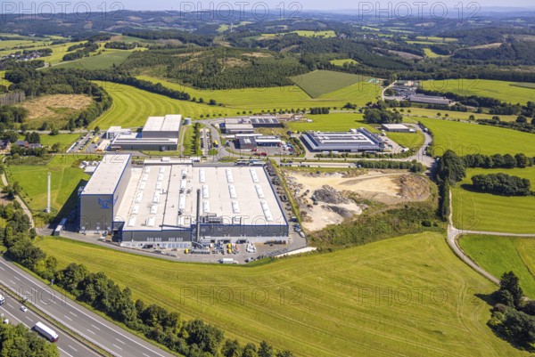 Aerial view, industrial area, industrial park Grünewald with construction site, motorway A45, hilly landscape with forest area, Drolshagen, Sauerland, North Rhine-Westphalia, Germany, motorway, DE, Europe, commercial enterprises, commercial area, commercial area, commercial property, commercial park, commercial location, commercial use, industrial area, industrial location, aerial view, aerial photography, aerial photography, Ruhr area, road traffic, overview, bird's eye view, birds-eyes view, overview