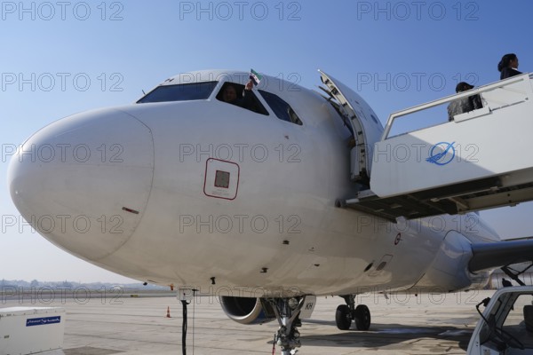 A captain and co-pilots celebrate after the first flight landed at Aleppo International Airport following the fall of Bashar al-Assad's regime. Aleppo, Syria. December 18, 2024, Aleppo, Aleppo, Syria