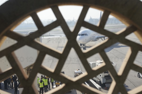 Passengers celebrate with Syrian revolutionary flags as the first flight lands at Aleppo International Airport in the presence of government officials following the fall of Bashar al-Assad's regime. Aleppo, Syria. December 18, 2024, Aleppo, Aleppo, Syria