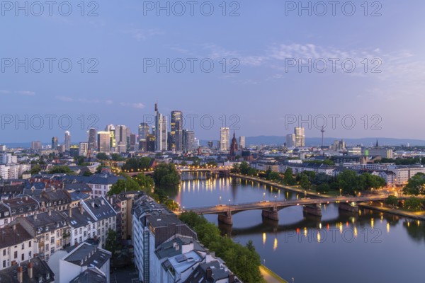 Illuminated Frankfurt City Downtown, Residential Buildings, Bridges and Main River at Morning Twilight. Wide Shot. Aerial View. Blue Hour. Hesse, Germany