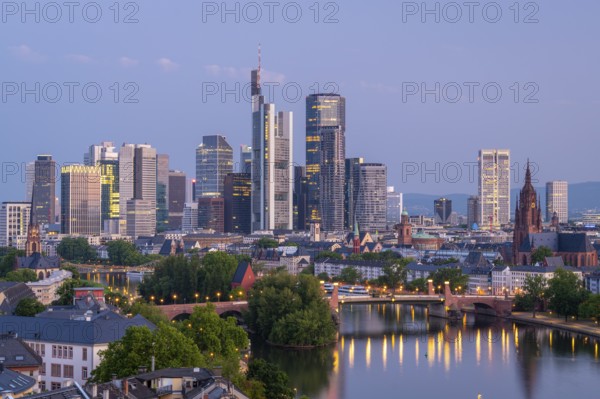 Illuminated Frankfurt City Skyline, Residential Buildings, Bridges and Main River at Morning Twilight. Aerial View. Blue Hour. Hesse, Germany