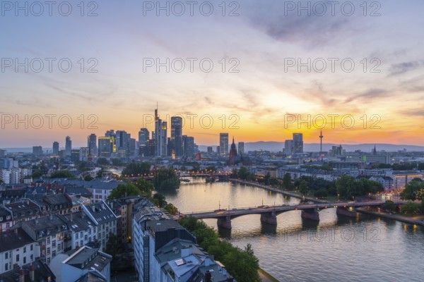 Frankfurt City Downtown, Residential Buildings, Bridges and Main River at Fiery Colorful Evening Twilight. Wide Shot. Aerial View. Blue Hour. Hesse, Germany