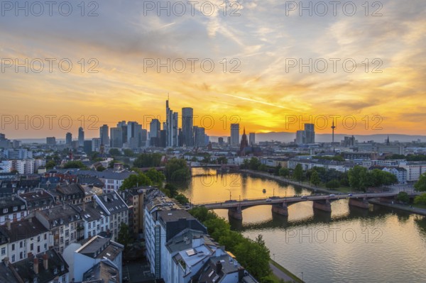 Frankfurt City Skyline, Residential Buildings, Bridges and Main River at Fiery Colorful Sunset. Wide Shot. Aerial View. Golden Hour. Hesse, Germany
