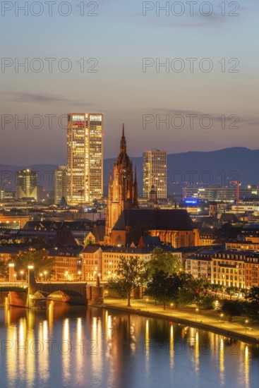 Illuminated Frankfurt Cathedral, Residential Buildings, City and Main River at Night. Aerial View. Blue Hour. Hesse, Germany