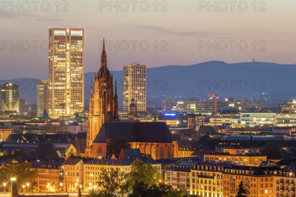 Illuminated Frankfurt Cathedral, Residential Buildings and City at Night. Aerial View. Blue Hour. Hesse, Germany