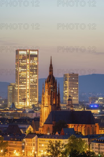 Illuminated Frankfurt Cathedral, Residential Buildings and City at Night. Aerial View. Blue Hour. Hesse, Germany