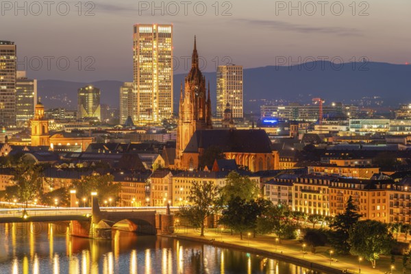 Illuminated Frankfurt Cathedral, Residential Buildings, City and Main River at Night. Aerial View. Blue Hour. Hesse, Germany