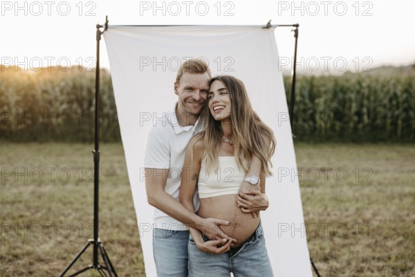 Pregnant, young woman with partner