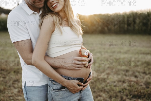 Pregnant, young woman with partner