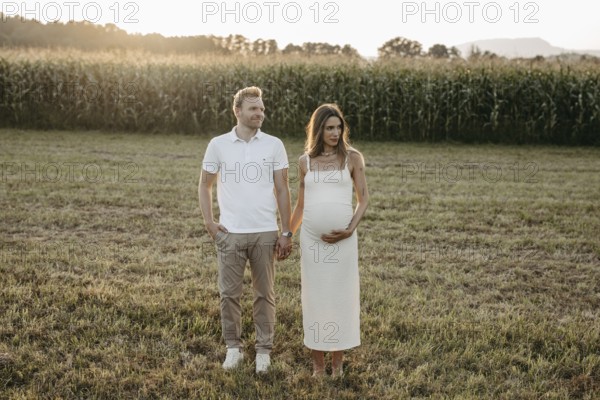 Pregnant, young woman with partner