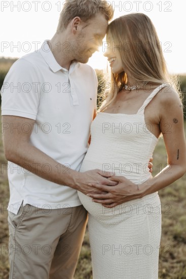 Pregnant, young woman with partner
