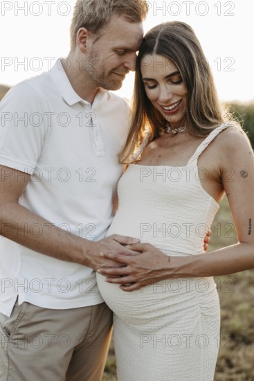 Pregnant, young woman with partner
