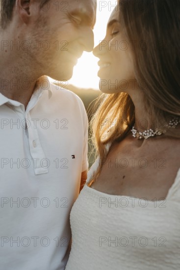 Young couple in love, nose to nose in front of the sunset