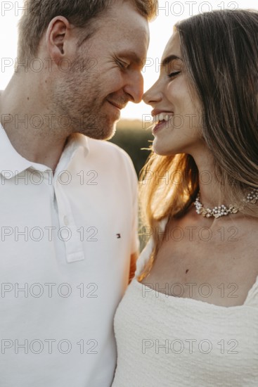 Young couple in love, nose to nose in front of the sunset