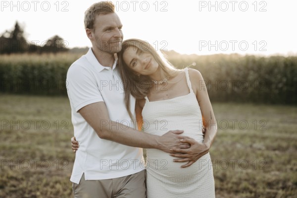 Pregnant, young woman with partner