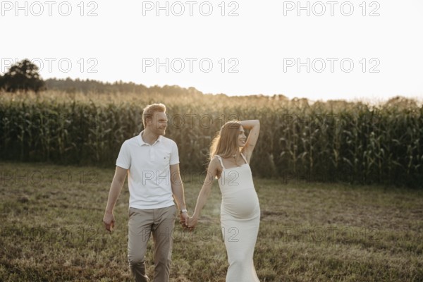 Pregnant, young woman with partner