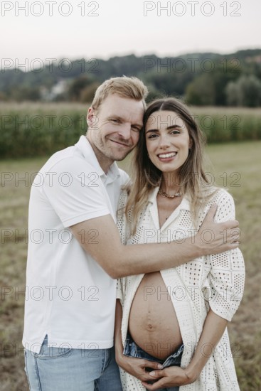 Pregnant, young woman with partner