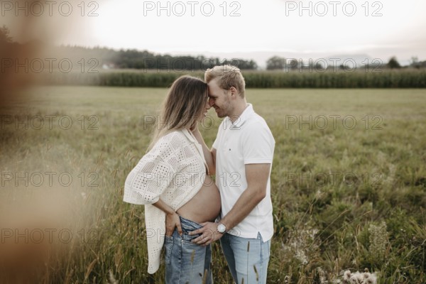 Pregnant, young woman with partner