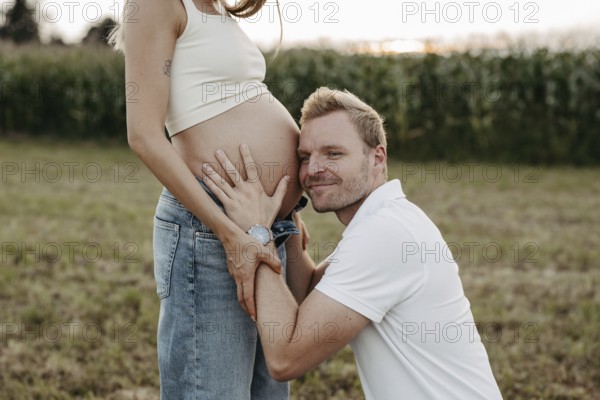 Pregnant, young woman with partner