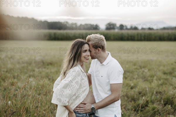 Pregnant, young woman with partner