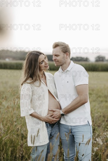 Pregnant, young woman with partner