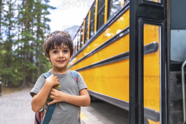 Elementary school student waiting at a mountain road, carrying a backpack and anticipating the arrival of the school bus, excited to embark on a new educational journey