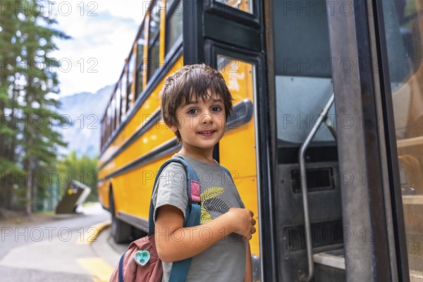 Preschool student with backpack embarking on a yellow school bus, excited for the new academic year, ready to learn and make new friends in elementary school
