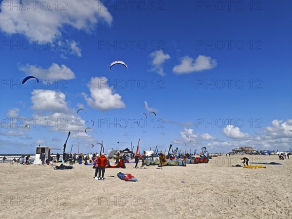 California kitesurfing Masters 2025 on the edge of the Wadden Sea UNESCO World Heritage Site, North Sea, beach, kitesurfing, sport, leisure, pile dwelling, summer, sun, blue sky, white clouds, Ording, Sankt Peter-Ording, Schleswig-Holstein, Germany