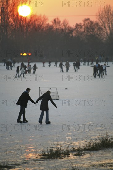 Ice skaters, sport, ice rink, winter, sunset, Moormerland, East Frisia, Germany
