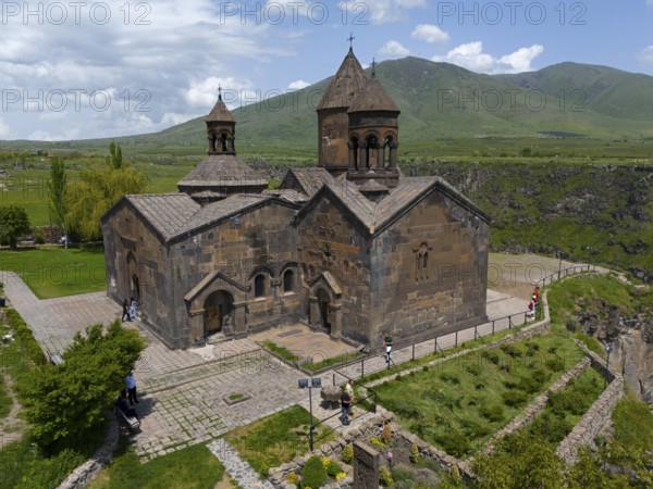 Stone church with natural backdrop and mountain view on paved terrain, aerial view, Saghmosavank Monastery, Saghmosavank, Saghmosavank, Salmosavank, Aragazotn Province, Armenia