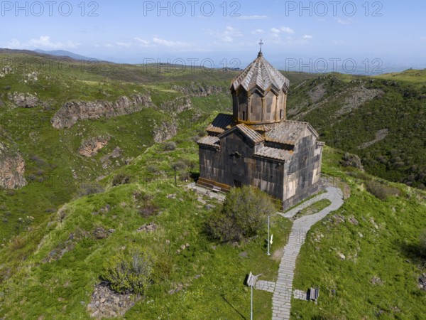 Church on a green hill with a view of a mountain landscape, aerial view, Church of the Mother of God, Vahramashen Church, Vahramashen Surp Astvatsatsin, Church of Amberd, Arkashian Gorge, Aragazotn Province, Armenia